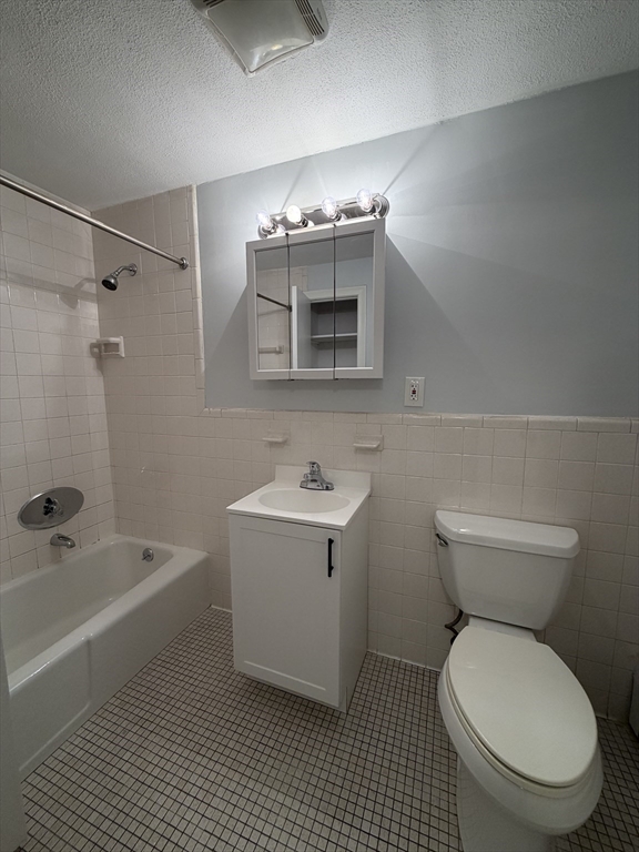 109 Trapelo Road, Unit 4 Waltham, MA 02452 - Photo 6 of 13 a bathroom with a toilet a sink and bathtub