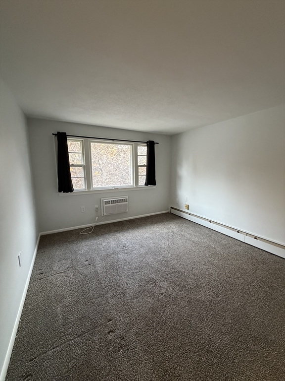 109 Trapelo Road, Unit 4 Waltham, MA 02452 - Photo 9 of 13 an empty room with a window