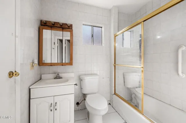 a bathroom with a toilet sink and a mirror