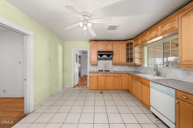a large kitchen with a white cabinets