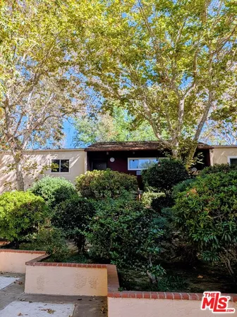 front view of a house with a tree