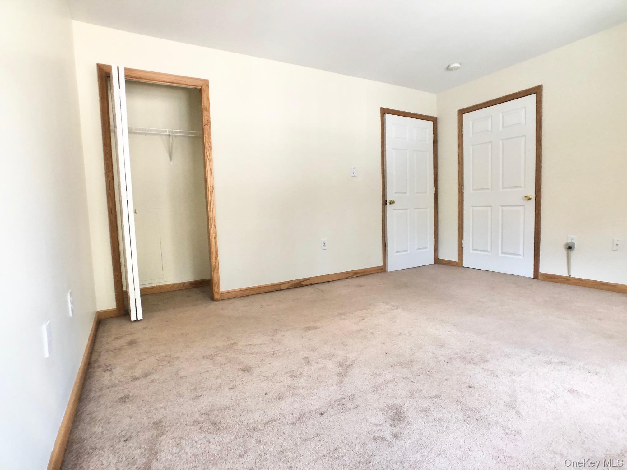331 West Post Road, Unit A White Plains, NY 10606 - Photo 6 of 9 Unfurnished bedroom with carpet and a closet