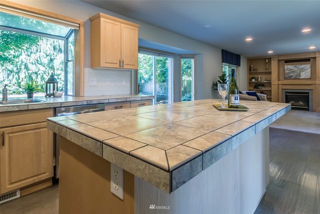 a kitchen with granite countertop a sink stainless steel appliances and cabinets