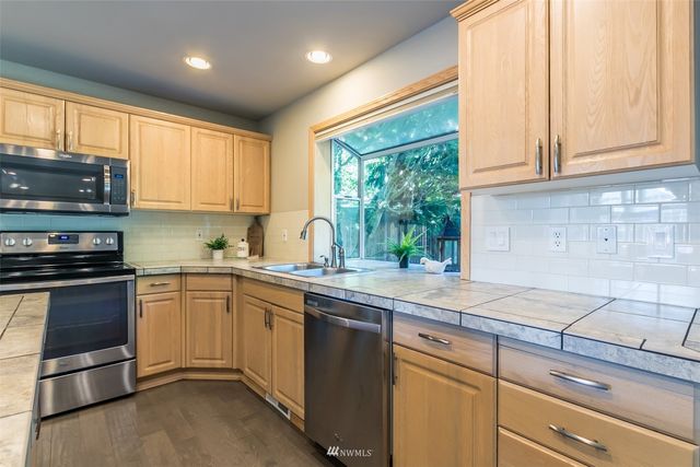 a kitchen with a sink stove and refrigerator