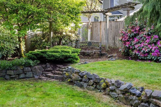 a view of a house with a yard and sitting area