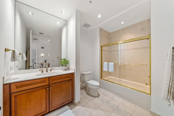 a bathroom with a double vanity sink toilet and shower