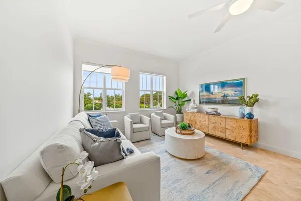 a living room with furniture and a potted plant
