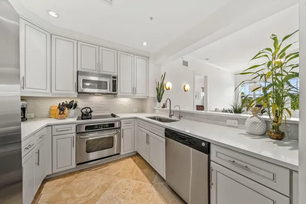a kitchen with a sink stove and cabinets