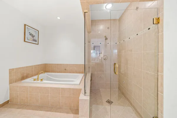 a bathroom with a bathtub and shower
