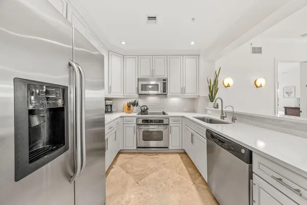 a kitchen with a sink stove and refrigerator