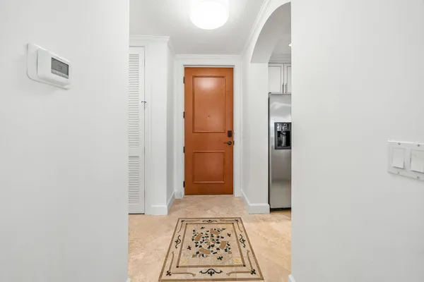 a view of a hallway with wooden floor and windows