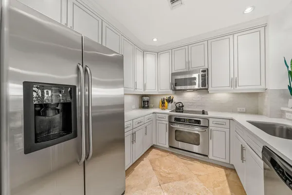 a kitchen with cabinets and stainless steel appliances