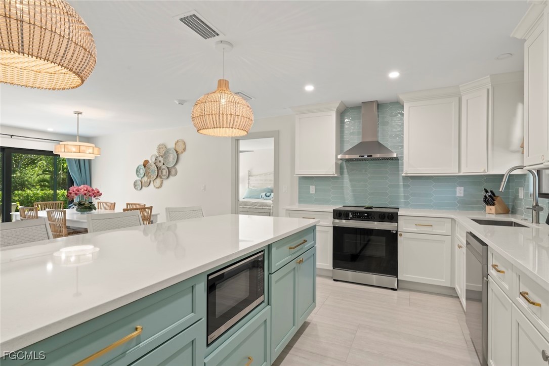 5117 Sea Bell Road, Unit G102 Sanibel, FL 33957 - Photo 18 of 49 a kitchen with kitchen island granite countertop a sink a stove and a wooden floors