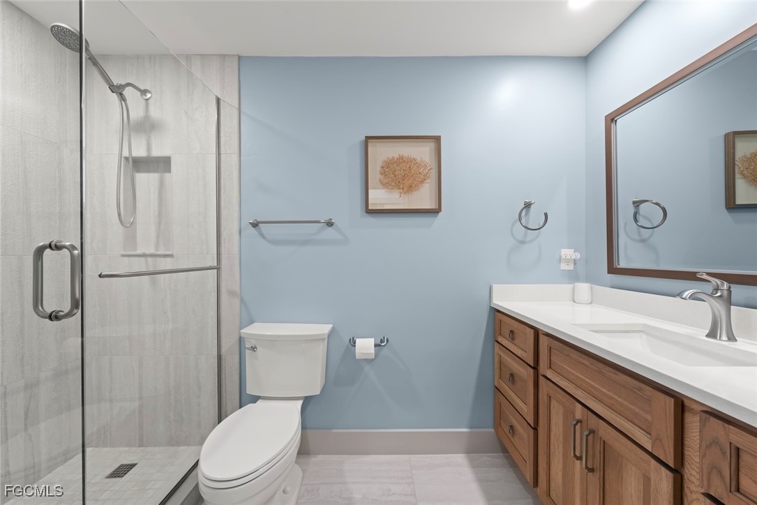 5117 Sea Bell Road, Unit G102 Sanibel, FL 33957 - Photo 27 of 49 a bathroom with a toilet sink vanity and mirror