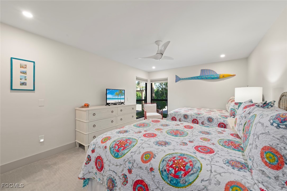 5117 Sea Bell Road, Unit G102 Sanibel, FL 33957 - Photo 32 of 49 a bedroom with a bed and a dresser
