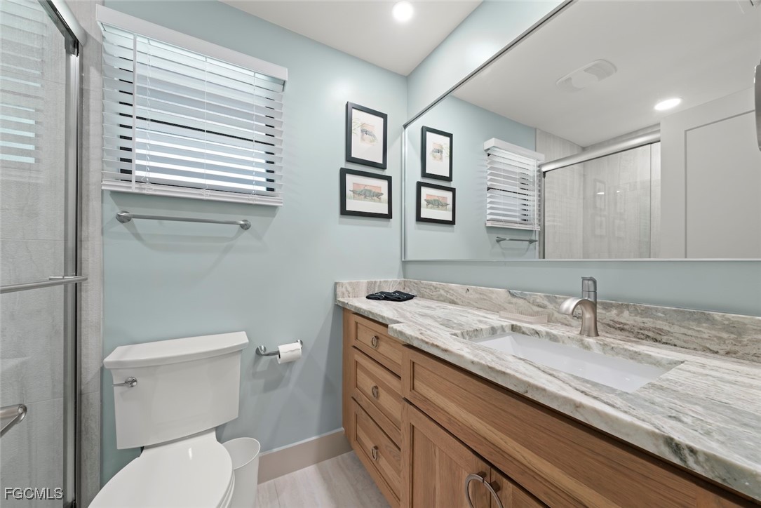 5117 Sea Bell Road, Unit G102 Sanibel, FL 33957 - Photo 36 of 49 a bathroom with a granite countertop toilet sink and mirror