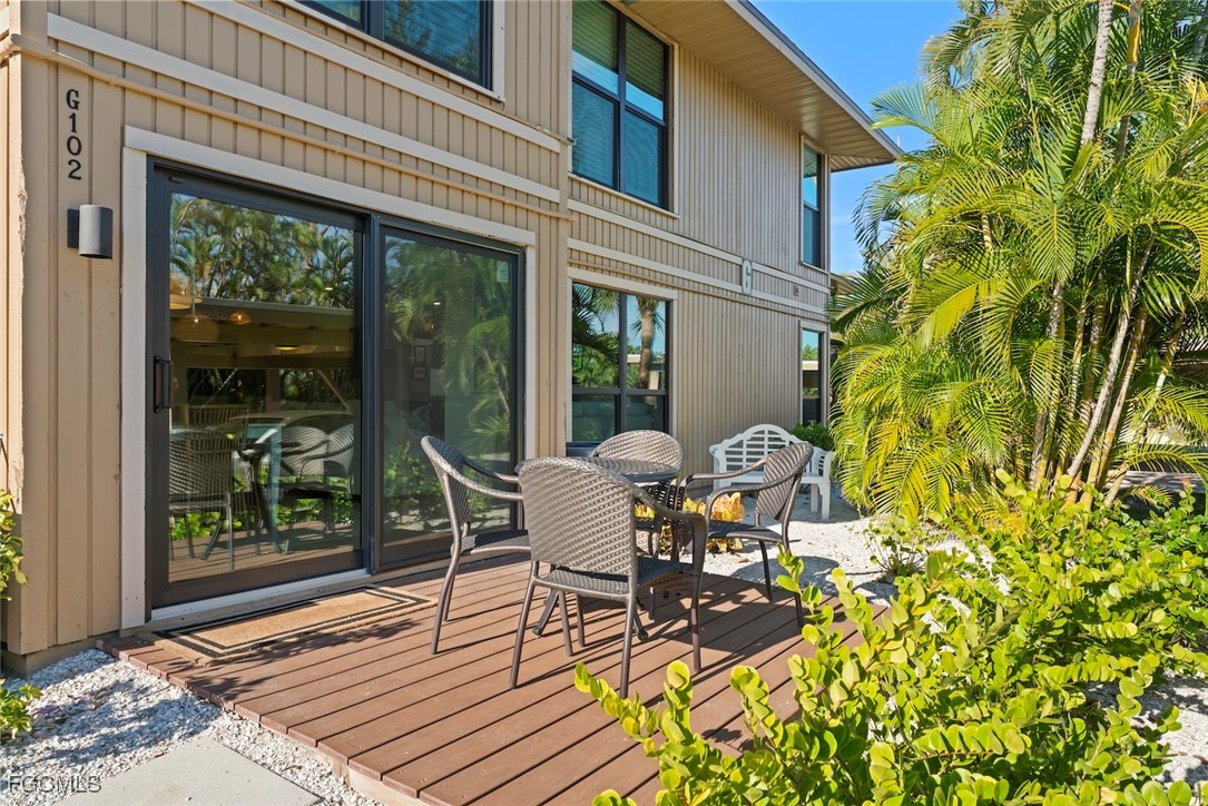 5117 Sea Bell Road, Unit G102 Sanibel, FL 33957 - Photo 37 of 49 a patio with table and chairs and potted plants