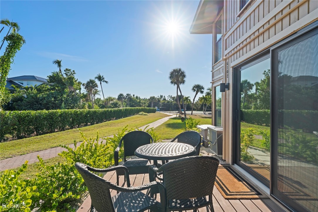 5117 Sea Bell Road, Unit G102 Sanibel, FL 33957 - Photo 39 of 49 a view of swimming pool with seating space and wooden floor