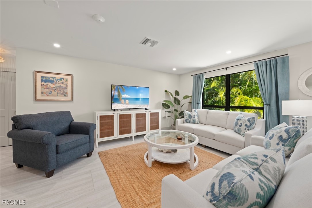 5117 Sea Bell Road, Unit G102 Sanibel, FL 33957 - Photo 6 of 49 a living room with furniture and a large window