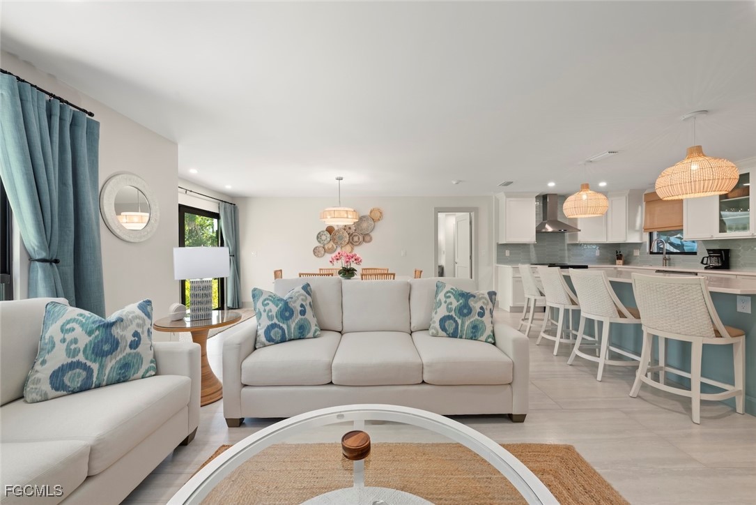 5117 Sea Bell Road, Unit G102 Sanibel, FL 33957 - Photo 9 of 49 a living room with furniture and a dining table with kitchen view