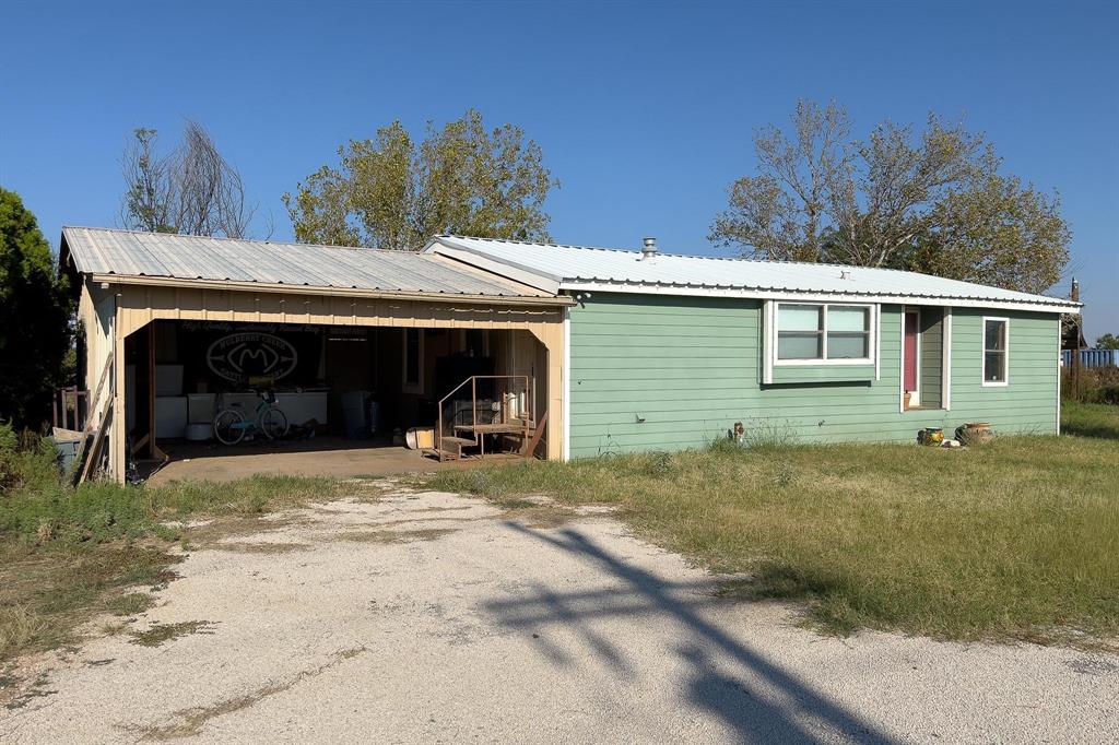 414 Bird Road Merkel, TX 79536 - Photo 2 of 19 a view of a house with a yard and garage