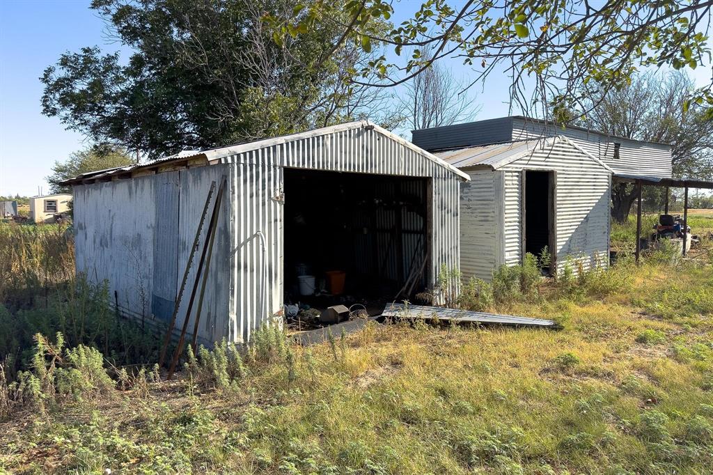 414 Bird Road Merkel, TX 79536 - Photo 9 of 19 a view of a house with large trees and wooden fence