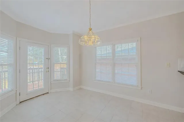 an empty room with windows and entrance