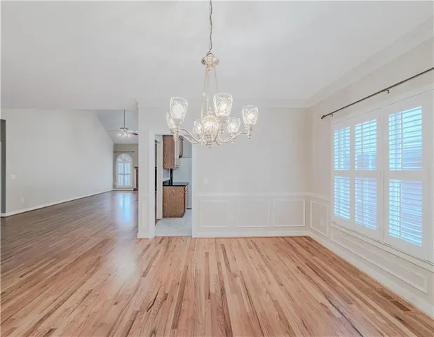 a view of a room with wooden floor and large windows