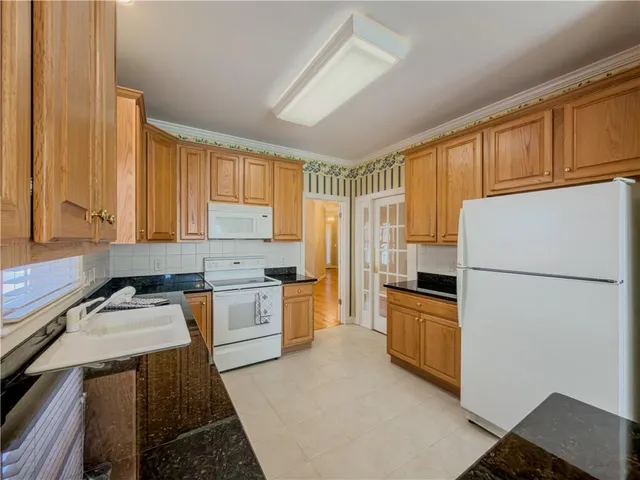 a kitchen with stainless steel appliances a refrigerator and a stove top oven