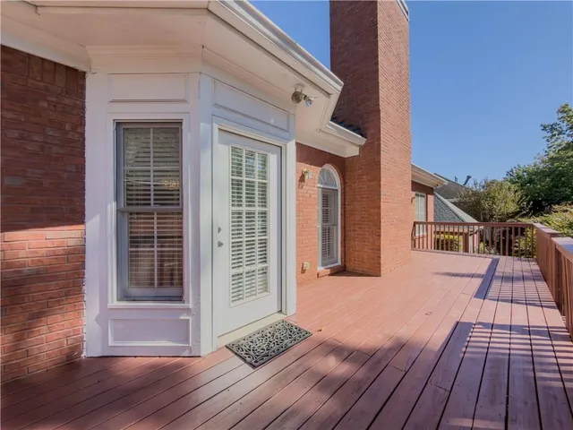 a front view of a house with a yard and swimming pool
