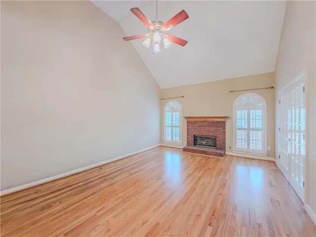a view of an empty room with a fireplace and a window
