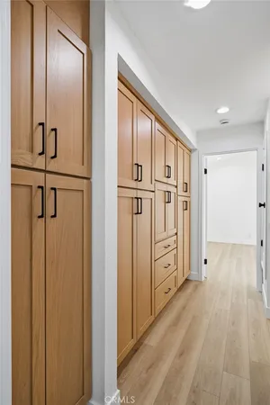 a view of an empty room with window and cabinet