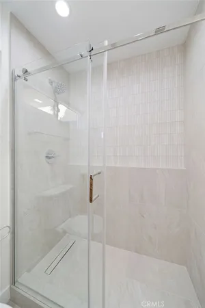 a bathroom with a glass shower door