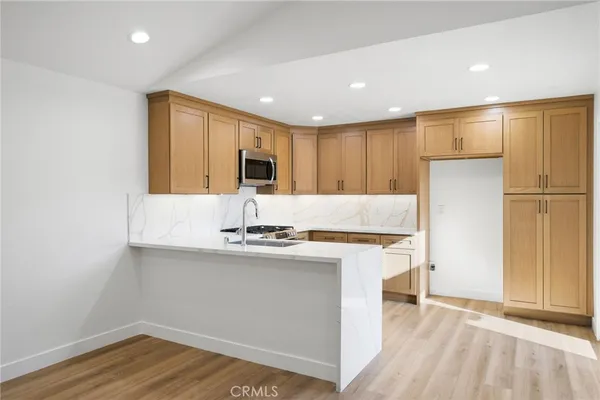 a kitchen with stainless steel appliances a refrigerator and a stove top oven