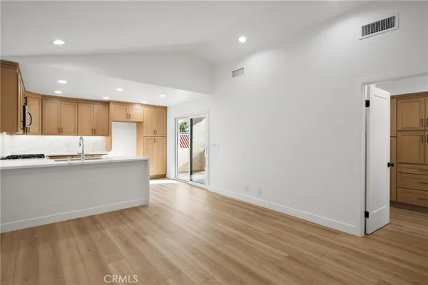 a large white kitchen with a refrigerator a sink and a stove