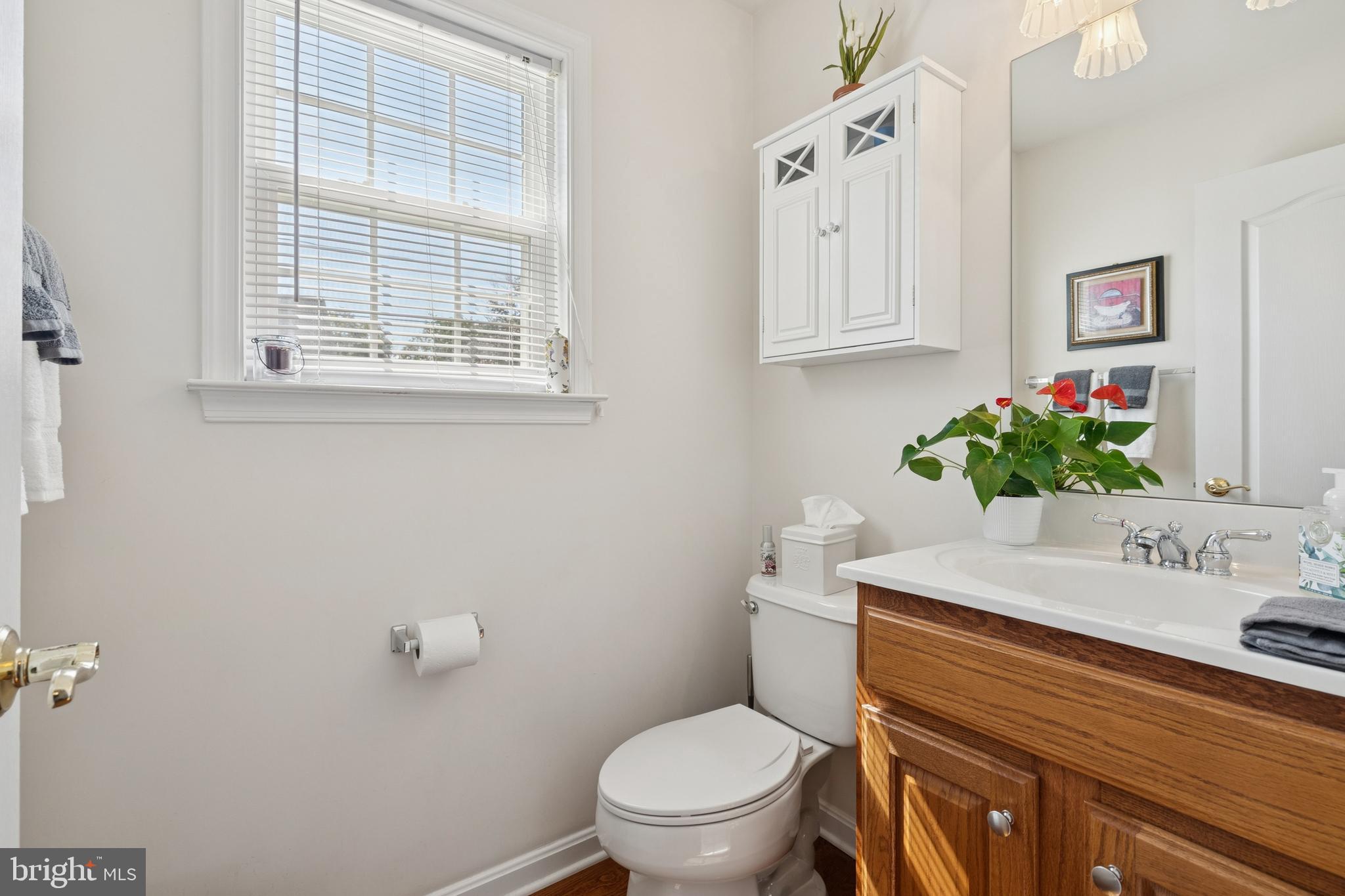 217 Cleveland Avenue Riverside, NJ 08075 - Photo 11 of 25 a bathroom with a toilet a sink and a window