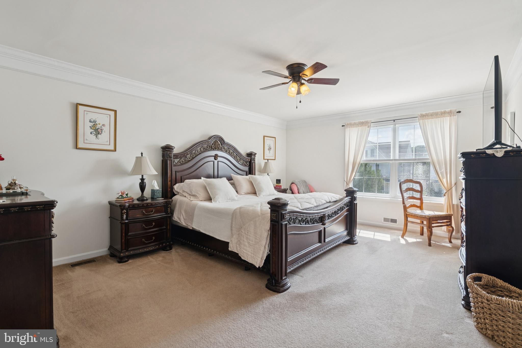 217 Cleveland Avenue Riverside, NJ 08075 - Photo 12 of 25 a spacious bedroom with a bed and a chandelier