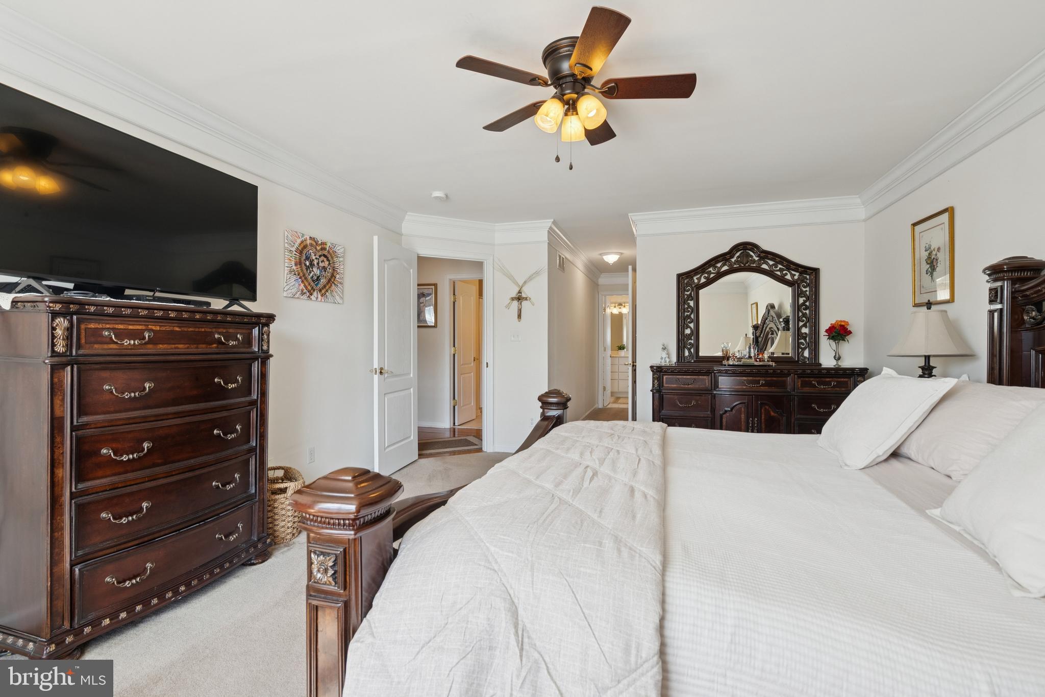 217 Cleveland Avenue Riverside, NJ 08075 - Photo 13 of 25 a bedroom with a bed a flat screen tv and a chandelier