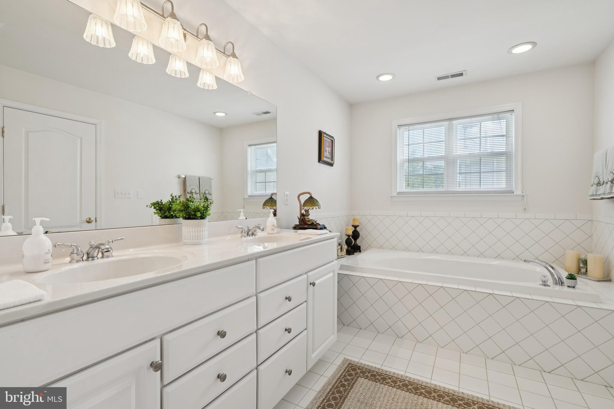 217 Cleveland Avenue Riverside, NJ 08075 - Photo 14 of 25 a bathroom with a sink a large mirror and a bathtub