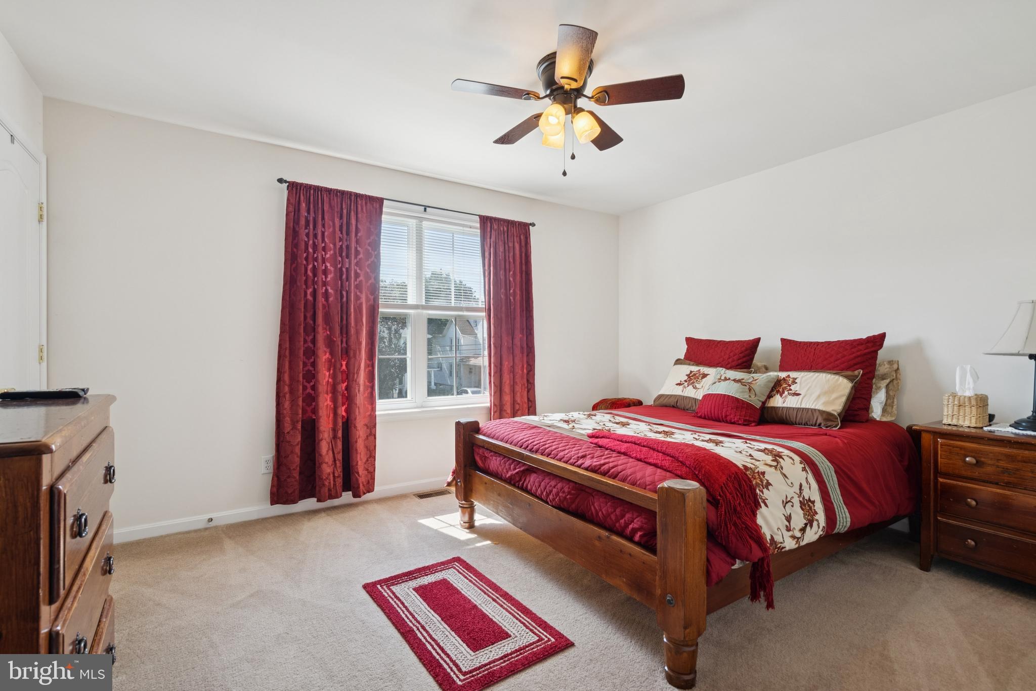 217 Cleveland Avenue Riverside, NJ 08075 - Photo 16 of 25 a bedroom with a bed and a chandelier