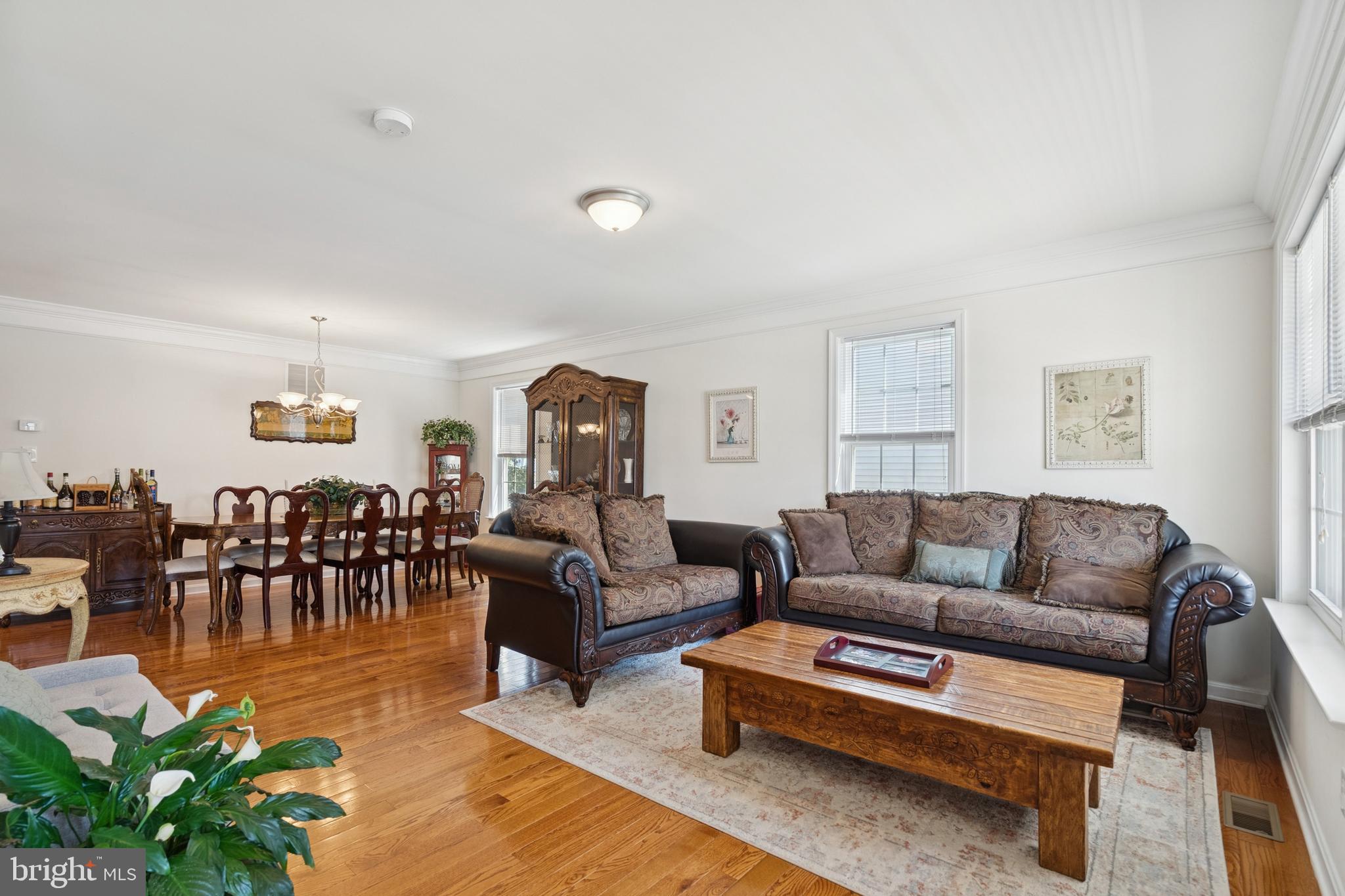 217 Cleveland Avenue Riverside, NJ 08075 - Photo 2 of 25 a living room with furniture and a dining table with wooden floor