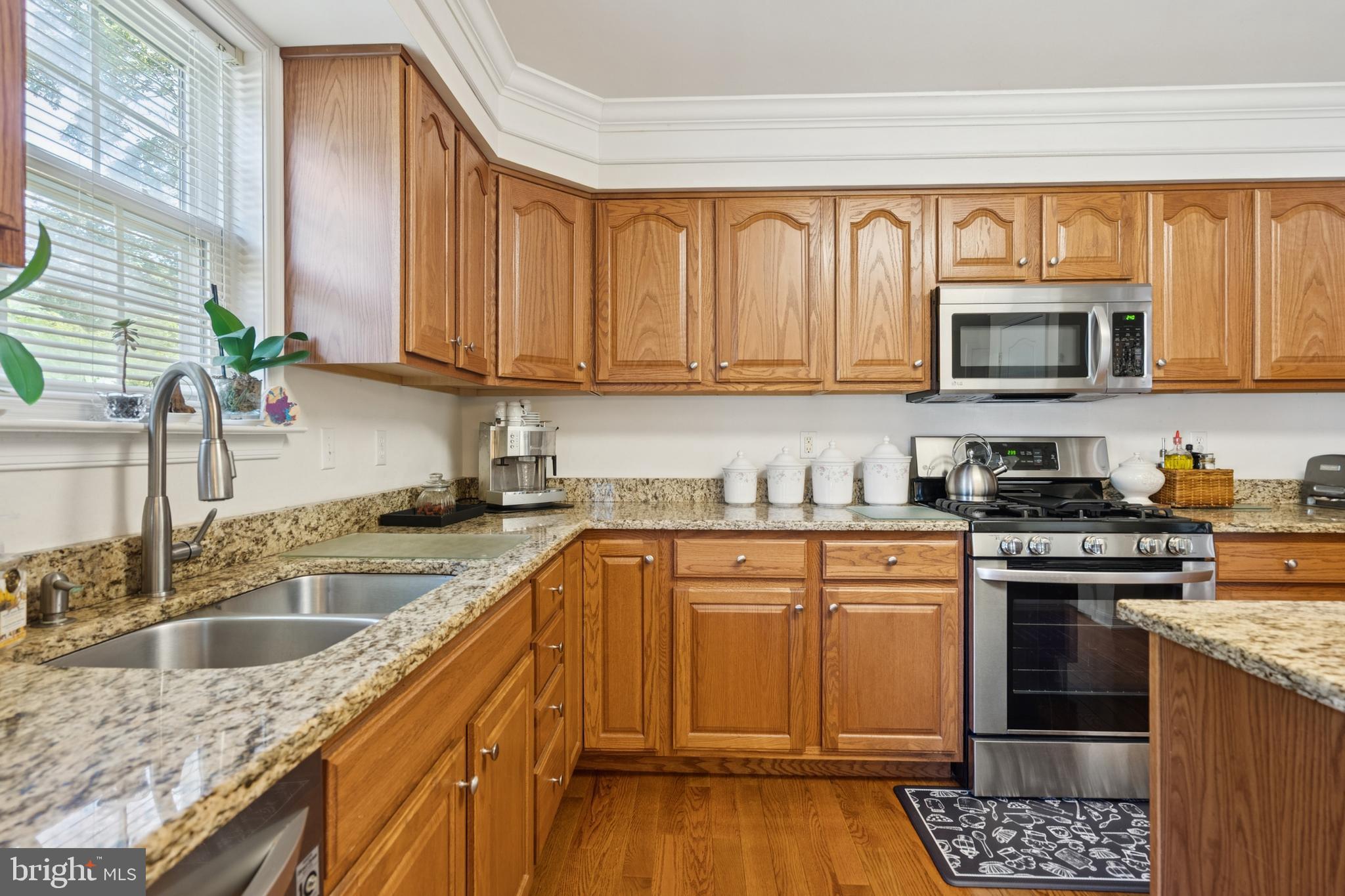 217 Cleveland Avenue Riverside, NJ 08075 - Photo 9 of 25 a kitchen with granite countertop a stove sink microwave and refrigerator
