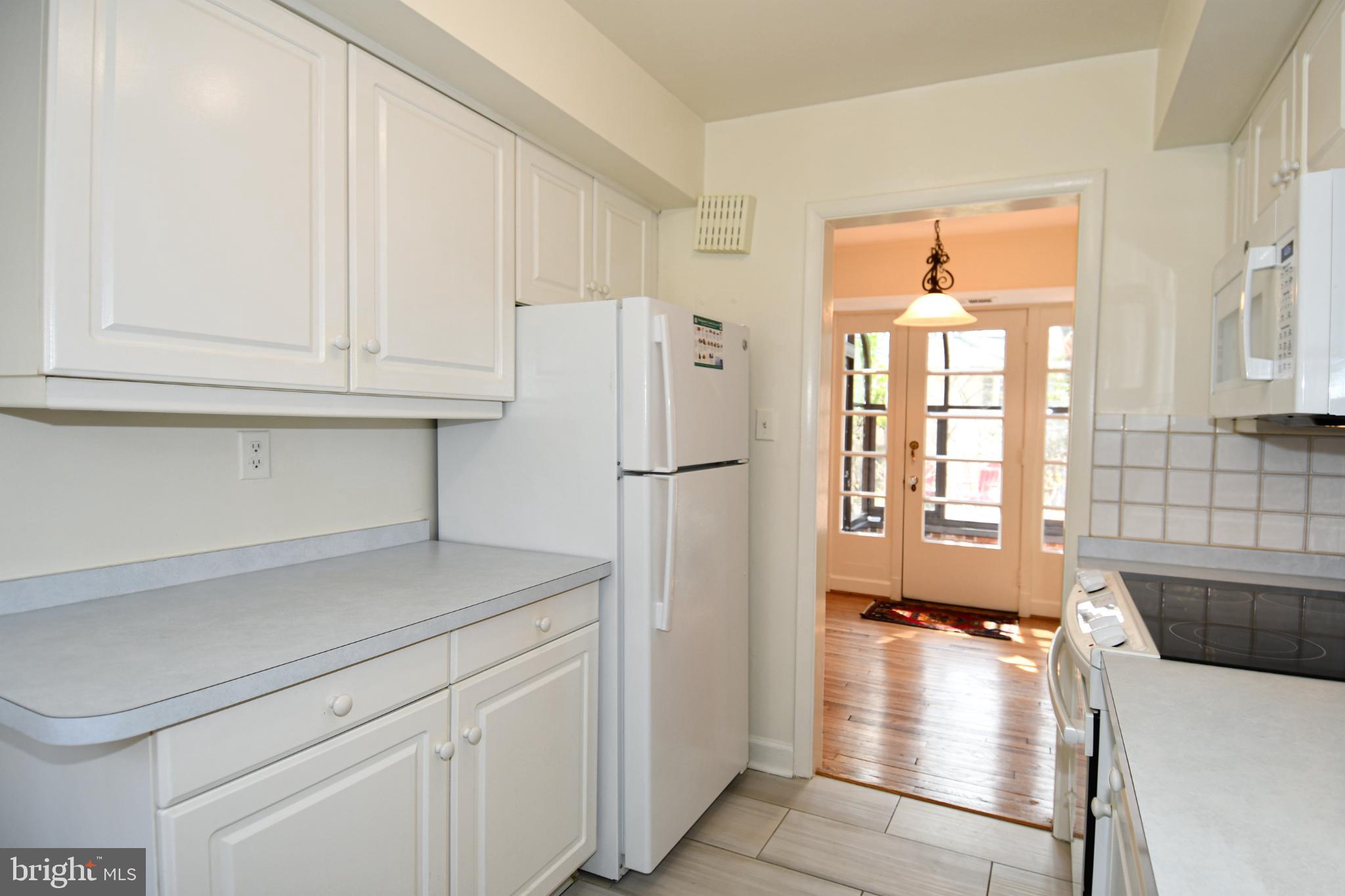 8520 Geren Road, Unit 183 Silver Spring, MD 20901 - Photo 20 of 34 a kitchen with stainless steel appliances granite countertop a refrigerator sink and white cabinets