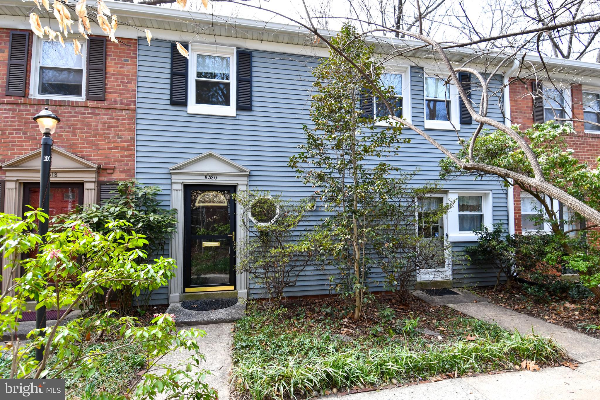8520 Geren Road, Unit 183 Silver Spring, MD 20901 - Photo 2 of 34 a view of a brick house with large windows and flower plants