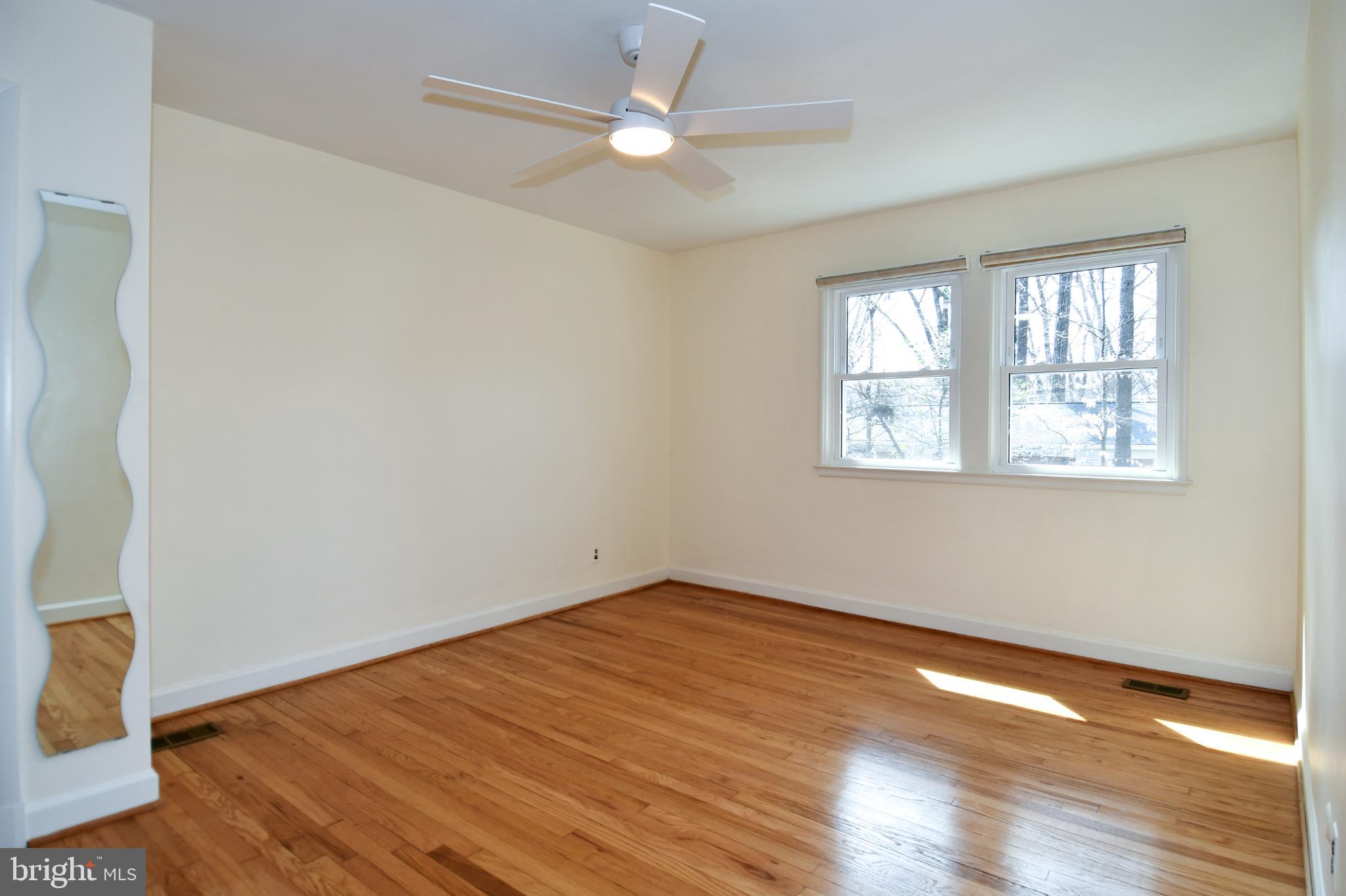 8520 Geren Road, Unit 183 Silver Spring, MD 20901 - Photo 27 of 34 wooden floor in an empty room with a window