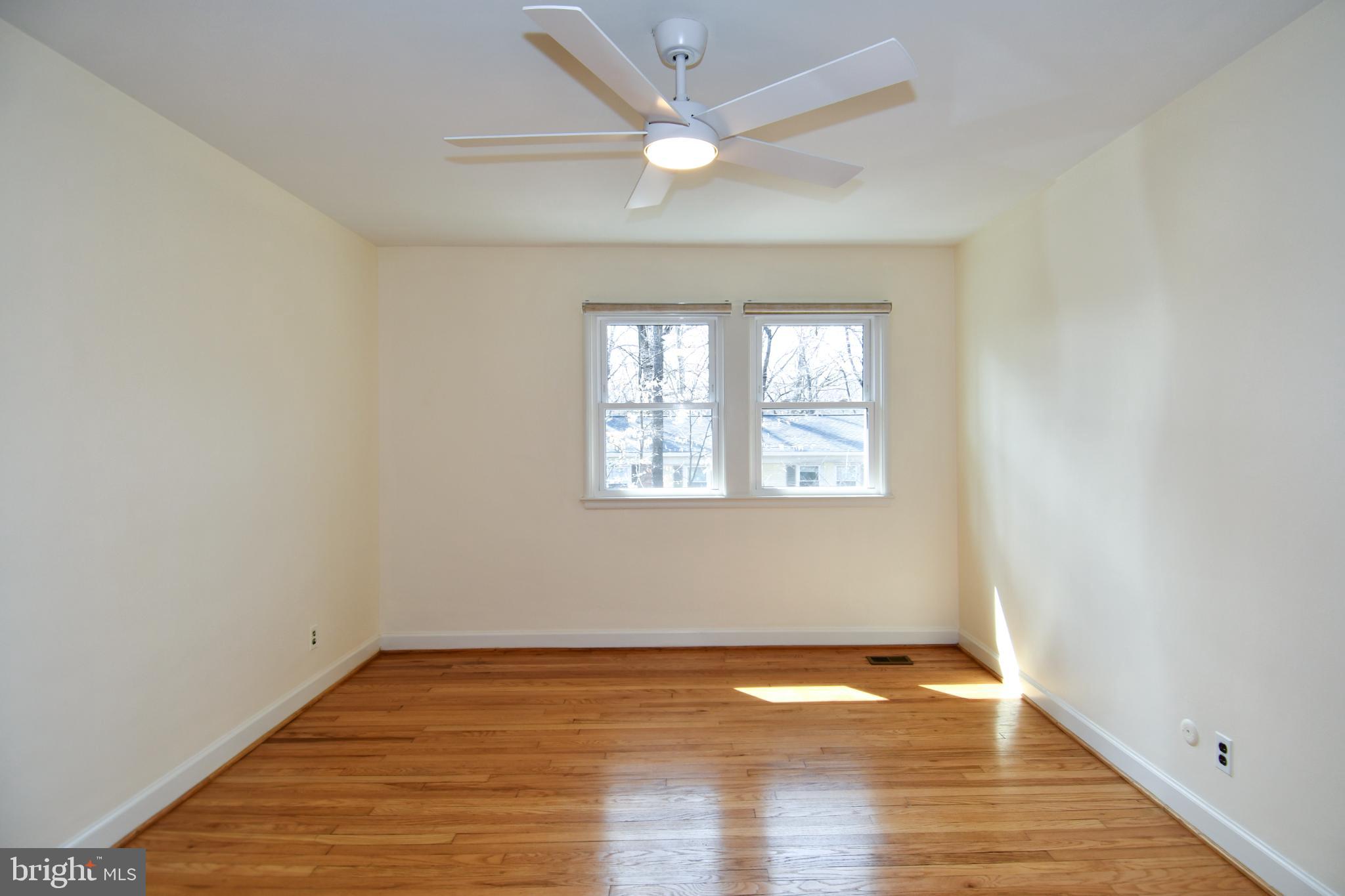 8520 Geren Road, Unit 183 Silver Spring, MD 20901 - Photo 28 of 34 an empty room with wooden floor and windows