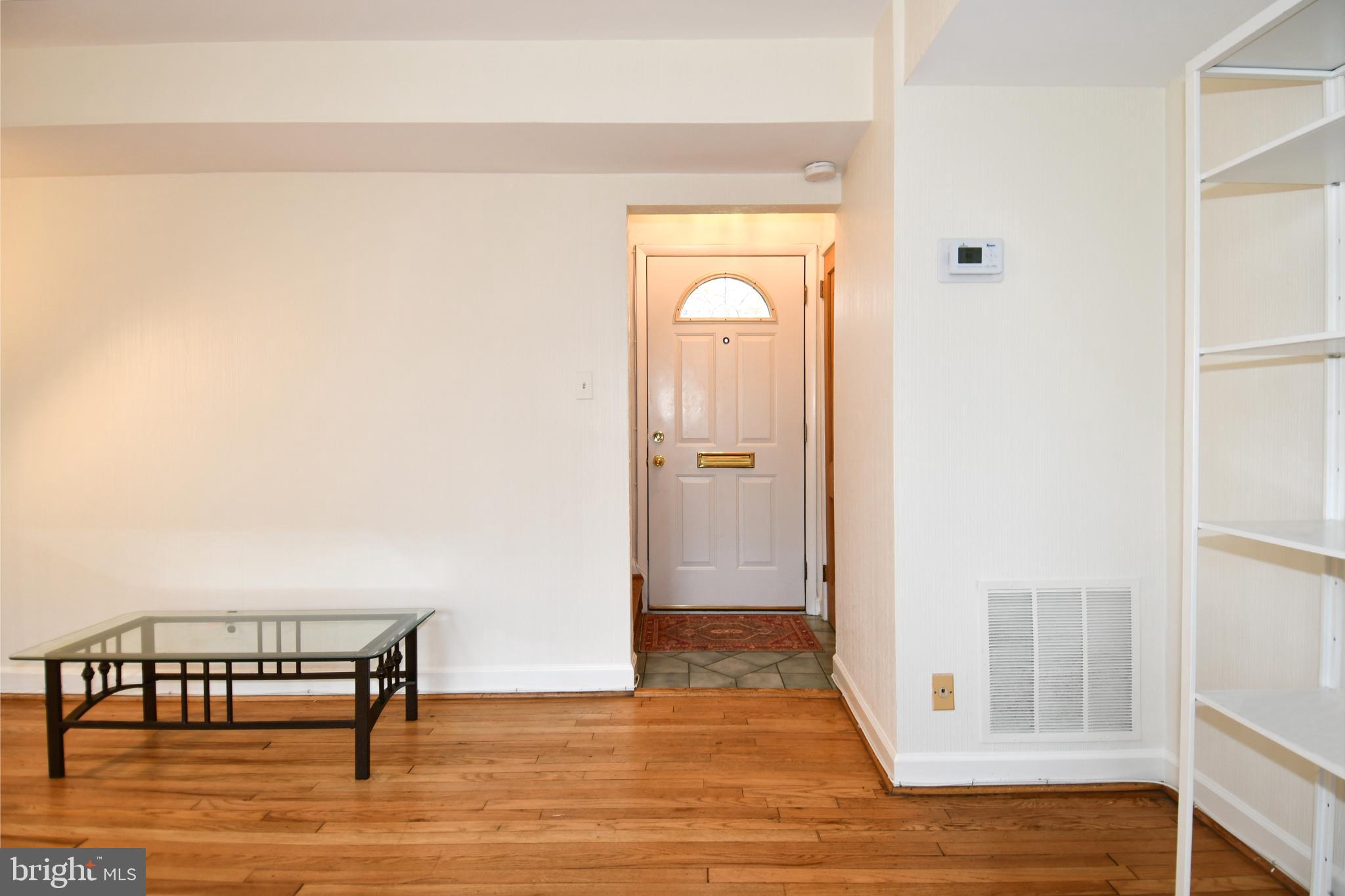 8520 Geren Road, Unit 183 Silver Spring, MD 20901 - Photo 3 of 34 a view of a room with wooden floor and chair