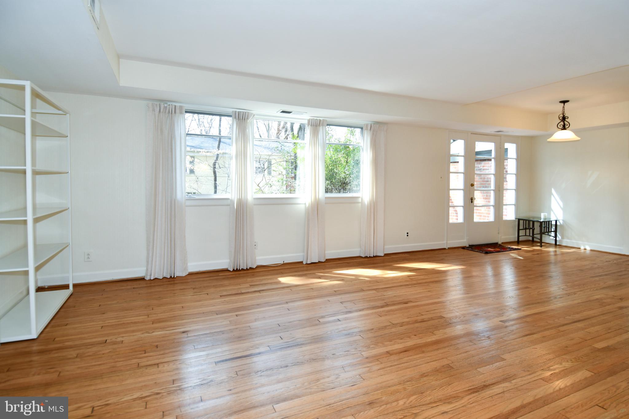 8520 Geren Road, Unit 183 Silver Spring, MD 20901 - Photo 5 of 34 an empty room with wooden floor and windows