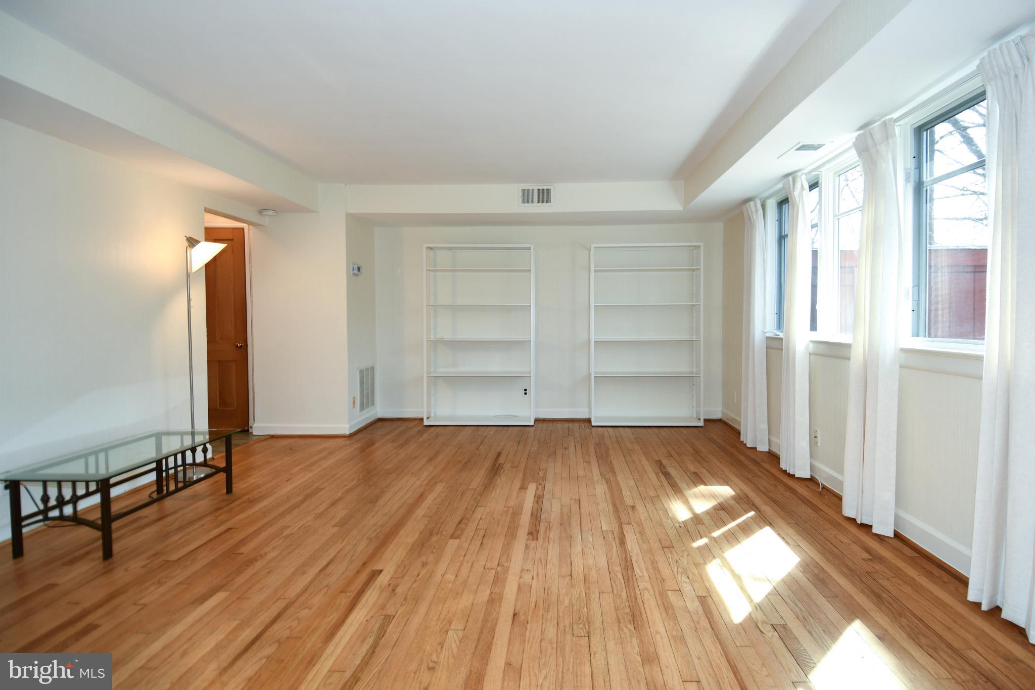 8520 Geren Road, Unit 183 Silver Spring, MD 20901 - Photo 7 of 34 wooden floor in an empty room with a window