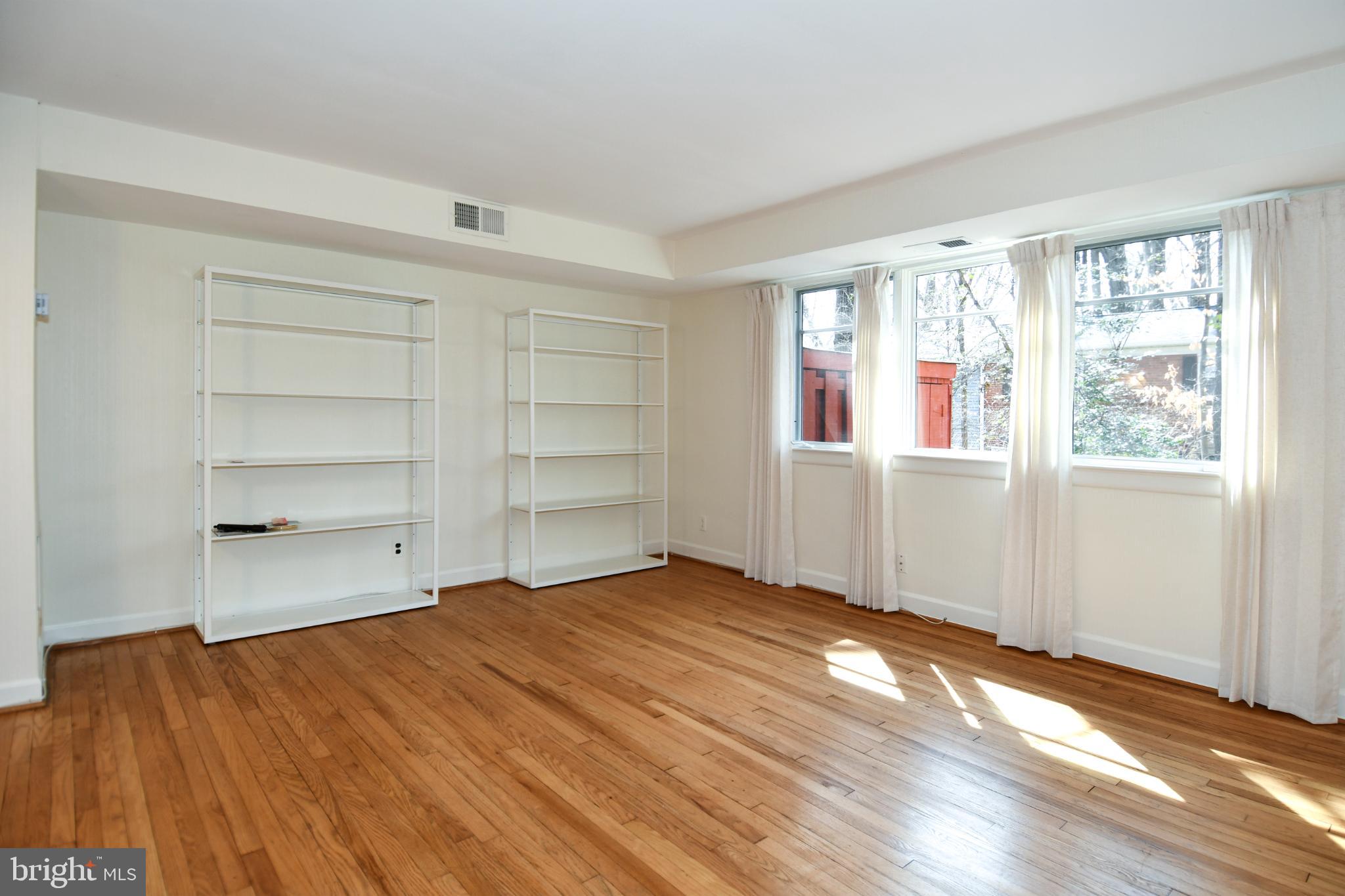 8520 Geren Road, Unit 183 Silver Spring, MD 20901 - Photo 8 of 34 wooden floor in an empty room with a window